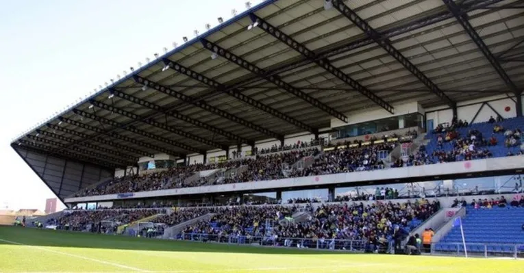 Không khí cuồng nhiệt của ngày thi đấu tại Kassam Stadium, với khán đài đầy ắp cổ động viên
