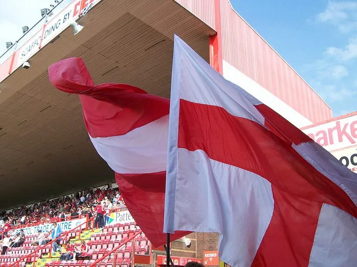 Những lá cờ cổ vũ màu đỏ và trắng của Bristol City tung bay trong gió tại sân vận động Ashton Gate